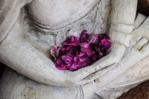 contemplative statue with purple flowers